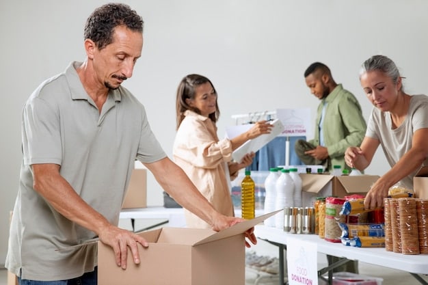 A group of volunteers is packing boxes with relief items in a warehouse. The backdrop features the insignia of an American disaster relief organization, along with boxes marked for various states in the US. The overall scene focuses on the organized and efficient distribution of aid.