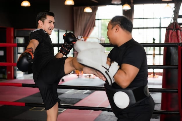 Jang Hyuk in a boxing stance, practicing punches with a trainer in a gym. He wears boxing gloves and athletic gear, showcasing intense focus and determination. The background contains typical gym equipment.